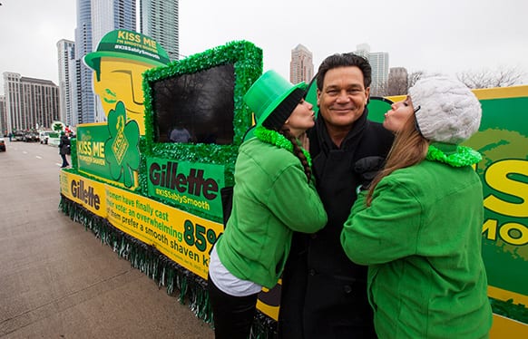 Football Hall of Fame star Dan “Danimal” Hampton declares “Kiss Me, I’m Smooth Shaven!” at the Gillette float with brand ambassadors during the St. Patrick’s Day Parade in Chicago.