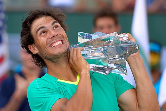 Rafael Nadal, of Spain, poses with the trophy after defeating Juan Martin del Potro, of Argentina, 4-6, 6-3, 6-4, in their match at the BNP Paribas Open tennis tournament.