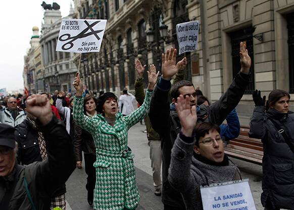 Protesters march as they hold a banner reading