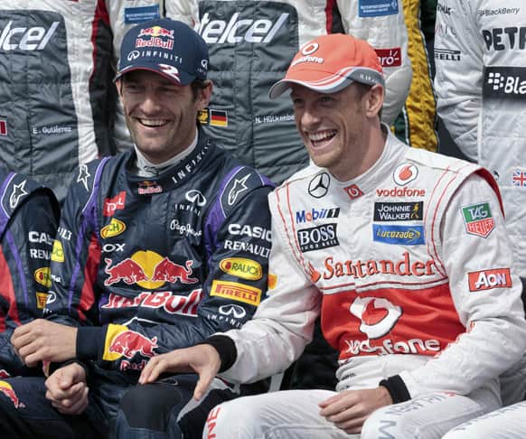 Red Bull driver Mark Webber, of Australia, and McLaren driver Jenson Button, of Britain, laugh during the official driver photo of the Australian Formula One Grand Prix at Albert Park in Melbourne, Australia.