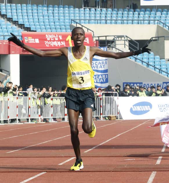 Franklin Chepwony of Kenya raises his arms as he crosses the finish line during the men`s race of the Seoul International Marathon at Olympic Stadium in Seoul, South Korea.