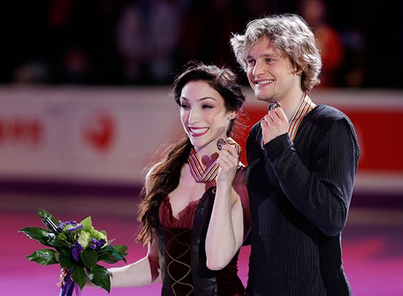 Meryl Davis and Charlie White, of the United States, pose on the podium as they win the first place of the free skate program in the ice dancing competition at the World Figure Skating Championships in London.
