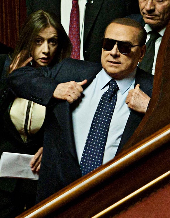 Former Italian Premier Silvio Berlusconi wears sunglasses as he attends the vote operations at the Senate, in Rome.