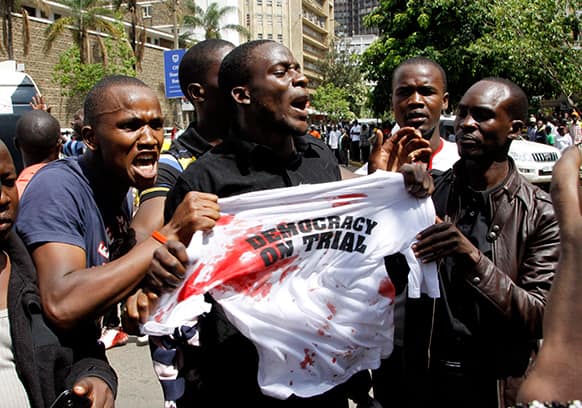 Supporters of Kenya`s Prime Minister Raila Odinga protest outside the Supreme Court as a case is filed over claims of massive fraud that took place during the country`s March 4 election, in Nairobi, Kenya.