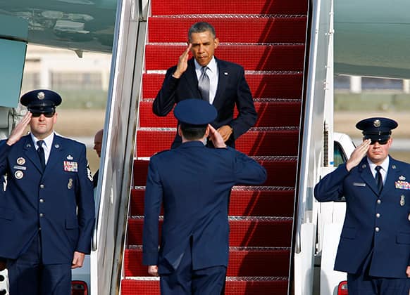 President Barack Obama salutes as he walks down the stairs of Air Force One upon arrival at Andrews Air Force Base, Md.