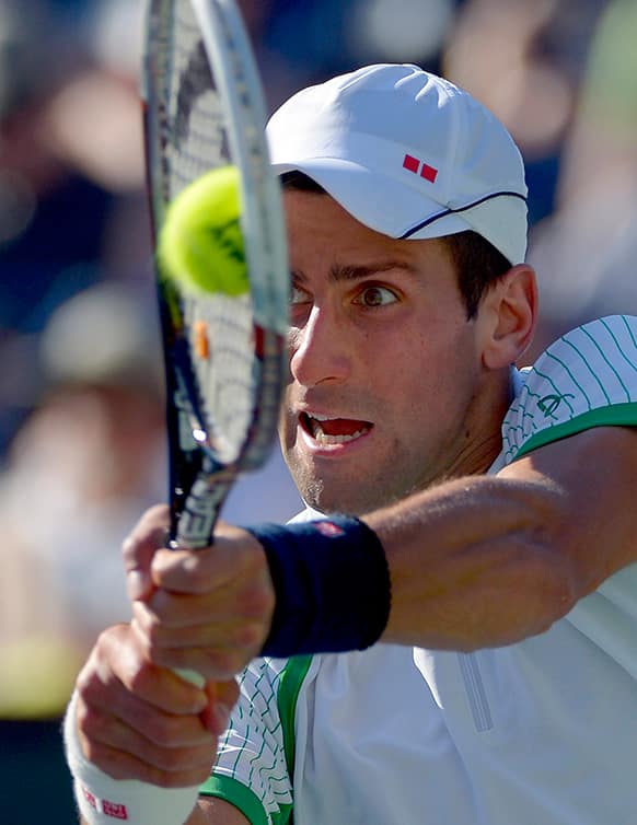 Novak Djokovic, of Serbia, returns a shot to Juan Martin del Potro, of Argentina, in their semifinal match at the BNP Paribas Open tennis tournament.