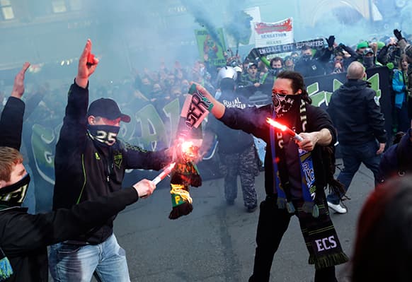 Seattle Sounders fans burn a Portland Timbers scarf during the
