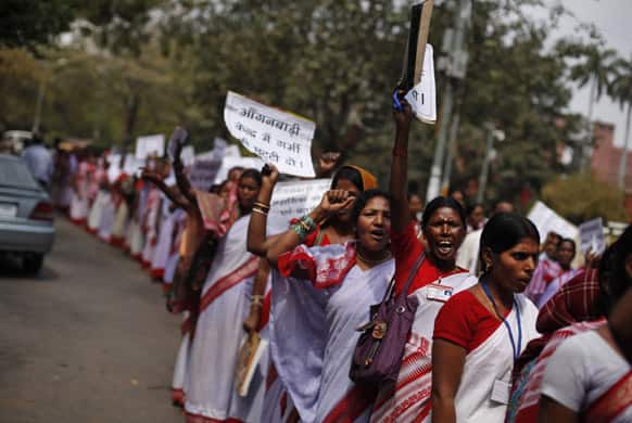 Anganwadi, or government sponsored child and mother care, workers shout slogans at a protest in New Delhi. Anganwadi workers are demanding that they should be recognized as government employees and their salaries must be increased, according to a press release.