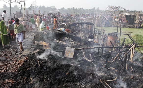 Smoke rises from the debris of shanties which caught fire early morning on the outskirts of Kolkata. More than 500 shanties were gutted in the fire. No casualties have been reported so far.