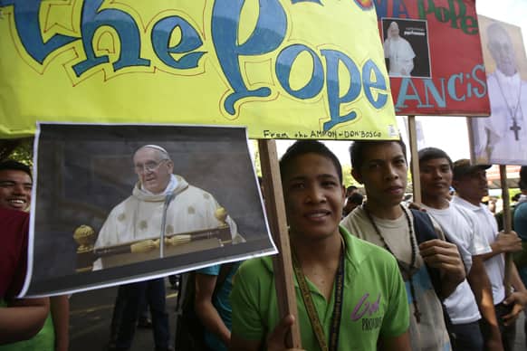Filipino Catholic devotees display placards and portraits of new Pope Francis during a prayer-rally outside the National Shrine of Mary Help of Christians at suburban Paranaque city, south of Manila, Philippines.