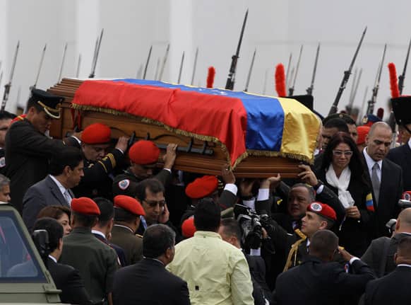 The coffin containing the remains of Venezuela`s late President Hugo Chavez is carried from the military academy, at the start of a procession to the military museum, his final resting place, in Caracas, Venezuela.