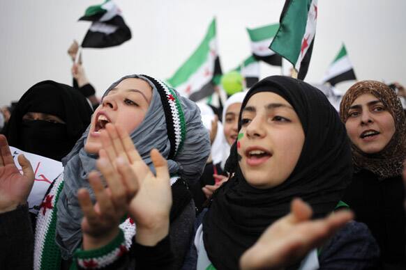 Syrian protesters chant anti-Assad slogans during a celebration to commemorate the second anniversary of the Syrian revolution, in Amman, Jordan.
