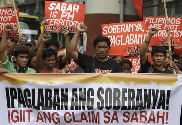 Protesters clench their fists during a rally near the Presidential Palace in Manila, Philippines.