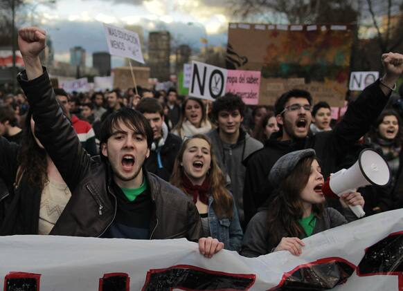 Students shout slogans during a protest as a part of a university students strike against financial cuts on education and in defence of the public education in Madrid, Spain.