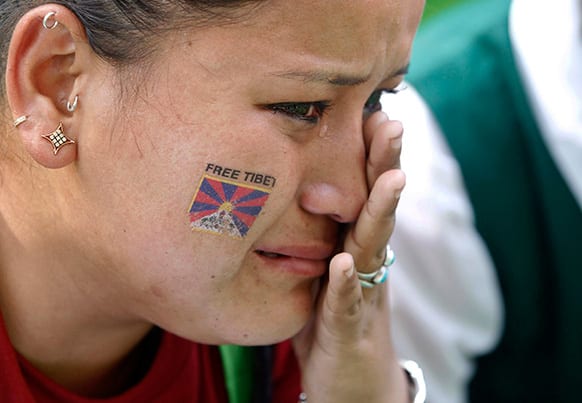 A Tibetan exile cries at a protest in New Delhi, India. Tibetan protesters chanted slogans against the Chinese government and called for an end to Chinese rule of Tibet.