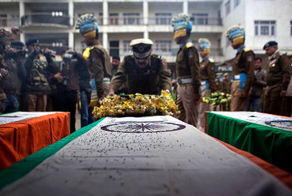 An Indian paramilitary officer lays a wreath on the coffin of his colleague at the police headquarters in Srinagar.
