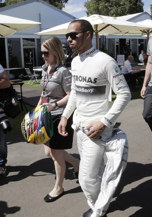 Mercedes driver Lewis Hamilton of Britain walks through the paddock at the Albert Park track ahead of the Australian Formula One Grand Prix at Albert Park in Melbourne.