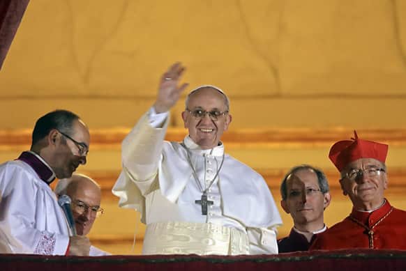 Pope Francis waves to the crowd from the central balcony of St. Peter`s Basilica at the Vatican. Cardinal Jorge Bergoglio, who chose the name of Francis is the 266th pontiff of the Roman Catholic Church.