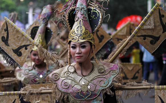 An artist performs during a cultural festival marking the end of Chinese New Year celebration in Bogor, West Java, Indonesia.