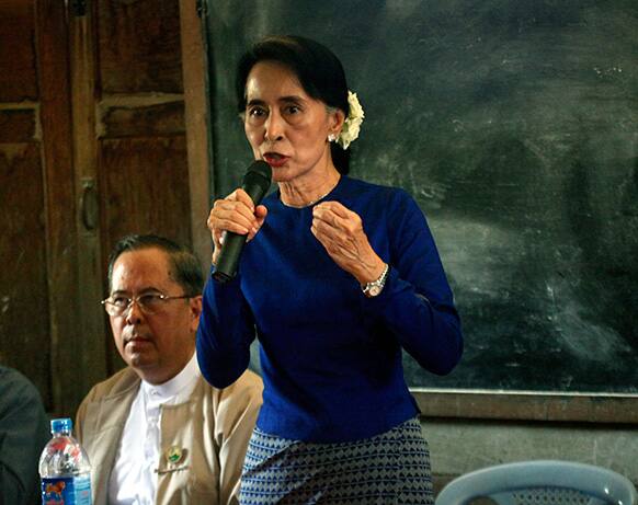 Myanmar opposition leader Aung San Suu Kyi speaks during a meeting with villagers at a primary school during a visit to an area near the Letpadaung copper mine, in Monywa township, central Myanmar.