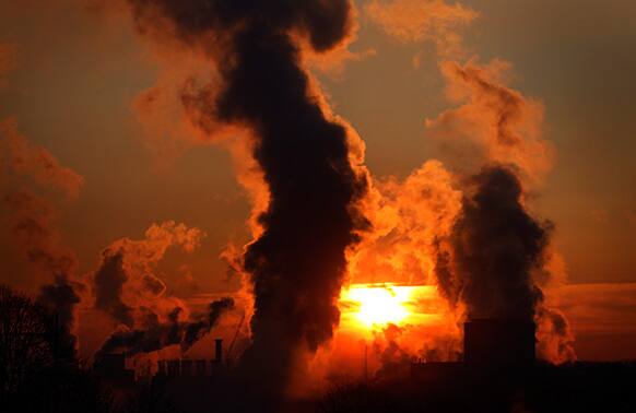 Smoke rises from an industrial area as the sun rises in Duisburg, Germany. After temperatures rose to a spring level past week, Germany had a night with clear sky and temperatures far below zero.