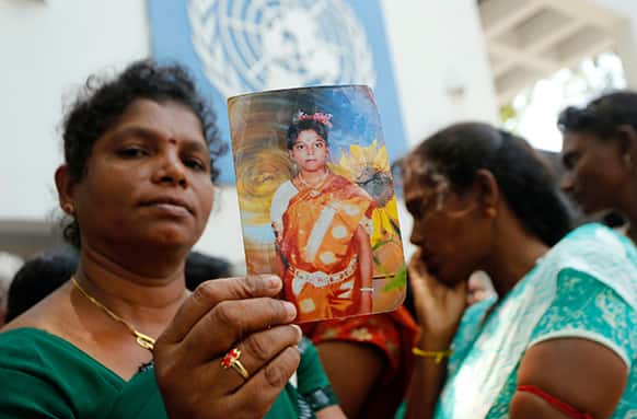 A Sri Lankan ethnic Tamil woman holds a photograph of her missing relative out side the UN office in Colombo, Sri Lanka.