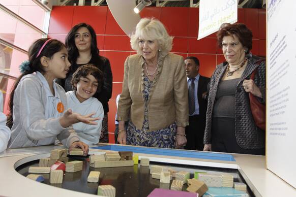 Britain`s Camilla Parker-Bowles, the Duchess of Cornwall, second right, and Jordanian Princess Wijdan Al Hashemi, right, visit the Children Museum at Al-Hussein Park in Amman, Jordan.