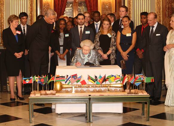 Britain`s Queen Elizabeth II, Head of the Commonwealth signs the Commonwealth Charter at a reception at Marlborough House, London.