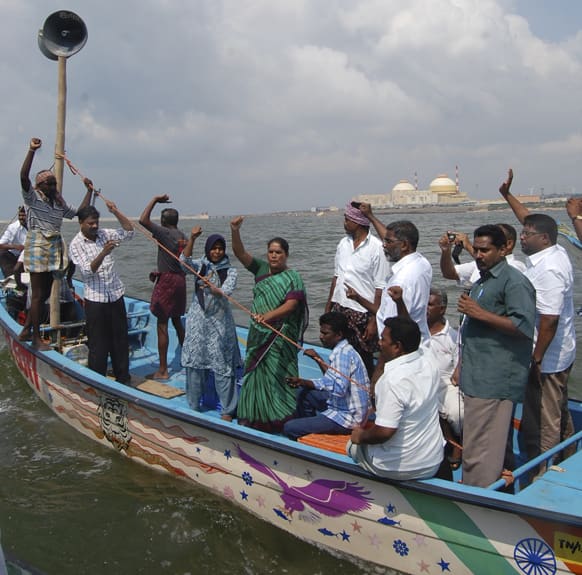 Anti nuclear protestors shout slogans from fishing boats as they protest against the Russian built Kudamkulam nuclear plant, background, on the Bay of Bengal coast, at Kudamkulam, Tamil Nadu.