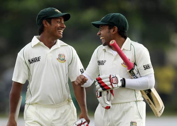 Bangladesh captain Mushfiqur Rahim, right, shares a light moment with batsman Mohammad Ashraful at the end of the third day of the first test cricket match between Sri Lanka and Bangladesh in Galle, Sri Lanka.