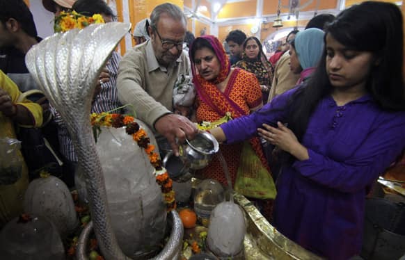 Hindu devotees perform rituals at the ancient Ranbireshwar temple during the Shivaratri festival in Jammu. Shivaratri, or the night of Shiva, is dedicated to the worship of Lord Shiva, the Hindu god of death and destruction.