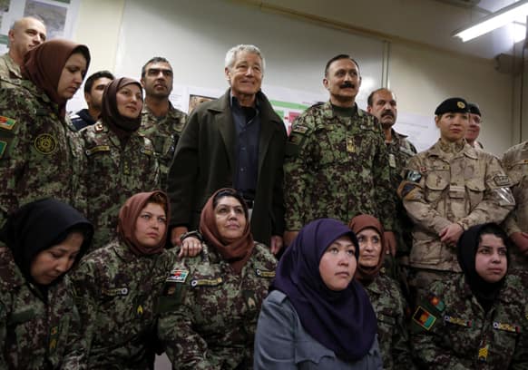 US Defense Secretary Chuck Hagel , center left, poses for a picture with female Afghan non-commissioned officers being trained during his visit to the Kabul Military Training Center in Kabul, Afghanistan.