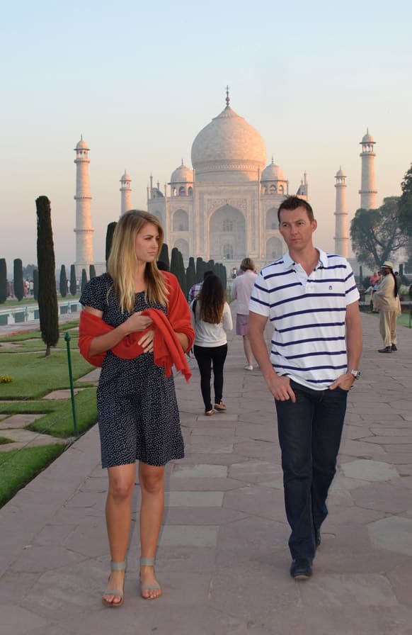 Former Australian cricketer Brett Lee and former Miss Australia Jesinta Campbell walk in front of the Taj Mahal in Agra, India. The two are in the country to shoot for a documentary.