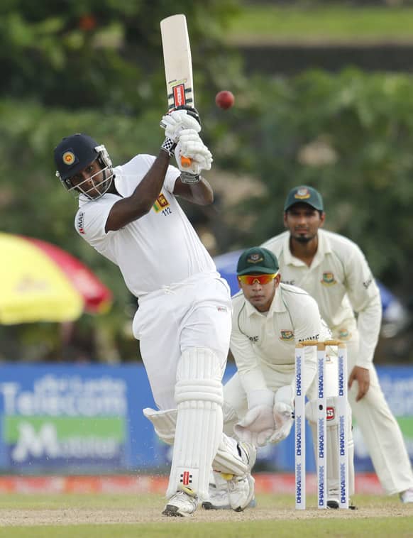 Sri Lanka`s captain Angelo Mathews bats in front of Bangladesh`s Mushfiqur Rahim during the first day of their first cricket test match in Galle, Sri Lanka.