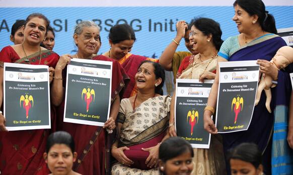 Indian gynecologists and obstetricians share a laugh as they participate in an event organized to create awareness about importance of the girl child, on International Women`s Day India in Bangalore.