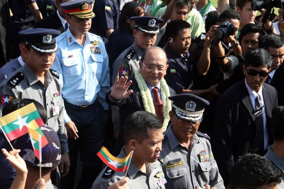 Myanmar President Thein Sein, waves at people upon his arrival from his tour to five European countries at Yangon International airport.