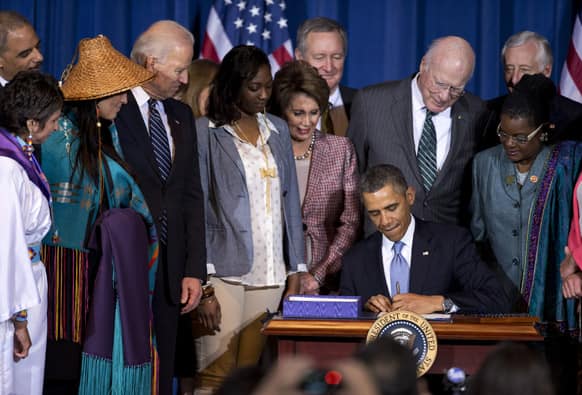 Barack Obama, joined by VP Joe Biden, Senate Patrick Leahy, D-Vt., House Minority Whip Steny Hoyer of Md., members of women’s organizations, law enforcement officials, tribal leaders, survivors, advocates and members of Congress, signs the Violence Against Women Act.