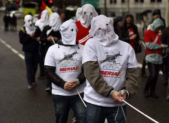 Iberia airline workers march dressed as slaves during a protest at Iberia headquarter in Madrid, Spain.