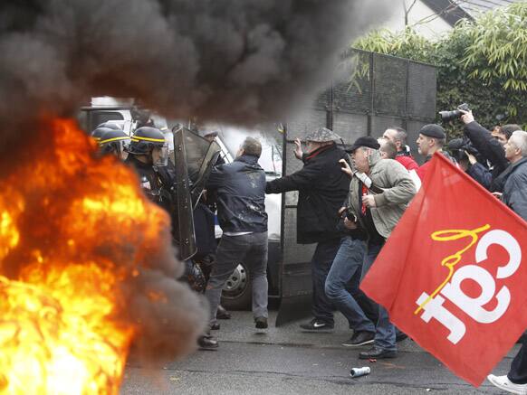 Goodyear employees scuffle with riot policemen during a demonstration against layoffs, in front of Goodyear headquarters in Rueil Malmaison, west of Paris.