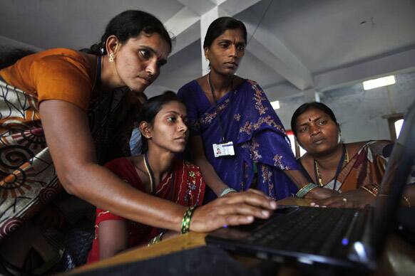 Women of Self Help Group (SHG) work on a laptop in Bibinagar village, on the eve of International Women’s Day, on the outskirts of Hyderabad.