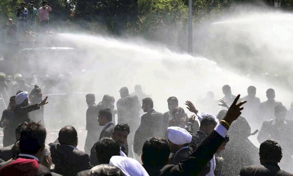 Police use water cannons against lawyers who tried to break police barricades during a protest in Chandigarh. The lawyers were protesting the registration of case against some advocates for allegedly manhandling a policeman.