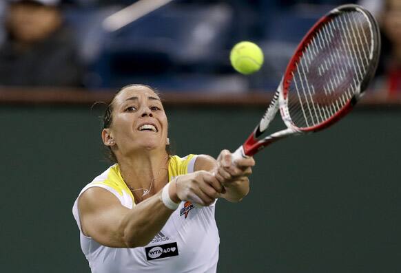 Flavia Pennetta, of Italy, returns a shot to Francesca Schiavone, of Italy, during the the BNP Paribas Open tennis tournament in Indian Wells, Calif.