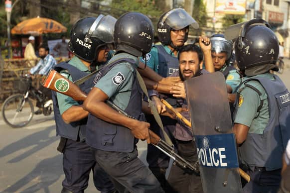 Bangladeshi police officers detain an activist of the main opposition group, the Bangladesh Nationalist Party (BNP), during clashes in Dhaka.