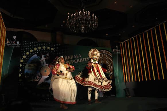 Traditional `Kathakali` dancers from the Kerala state perform during a road show held to promote Kerala tourism in Kolkata.