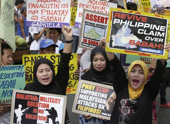 Filipino Muslims are joined by other protesters as they shout slogans during a rally near the Presidential Palace in Manila, Philippines.