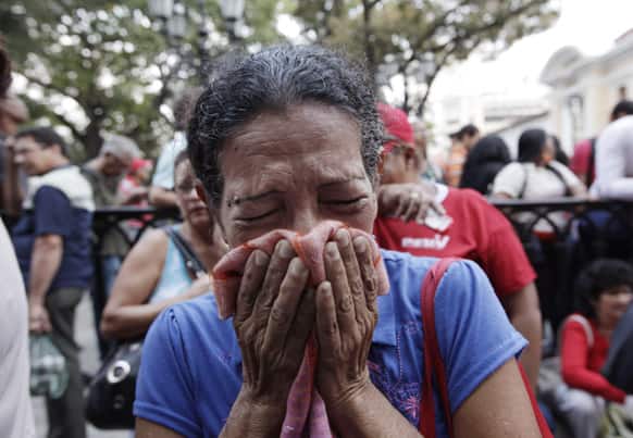 A supporter of Venezuela`s President Hugo Chavez cries as she learns that Chavez has died through an announcement by the vice president in Caracas, Venezuela.