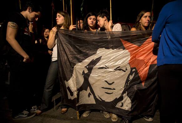 Argentine supporters of Venezuela`s President Hugo Chavez gather in front of Venezuela`s embassy in Buenos Aires, Argentina. Venezuela`s Vice President Nicolas Maduro announced that Chavez died on Tuesday at age 58 after a nearly two-year bout with cancer.