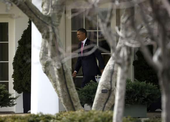 President Barack Obama walks out of the Oval Office of the White House in Washington before his departure on the Marine One helicopter to Walter Reed National Military Medical Center.