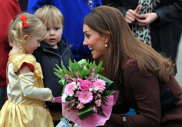 Britain`s Catherine, Duchess of Cambridge receives flowers from 3-year old Isobelle Laursen during her visit to Humberside Fire and Rescue Station in Grimsby, north Engalnd.