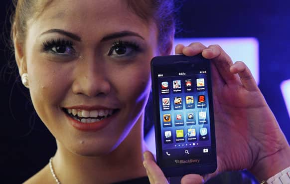 A model poses with the new Blackberry Z10 smartphone during its launch in Jakarta, Indonesia, Monday, March 4, 2013. The Z10 is priced at Indonesia Rp.6,999,000 (US$723 or EUR 555 ).